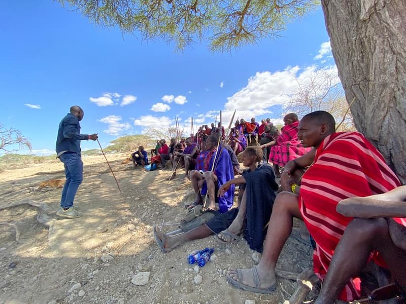 Roimen and Mussa talk with the Nyangulo (the warrior age set) in Ndutu, Ngorongoro.
